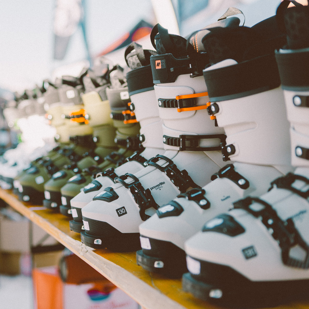 Rows of new ski boots lined up on a shelf
